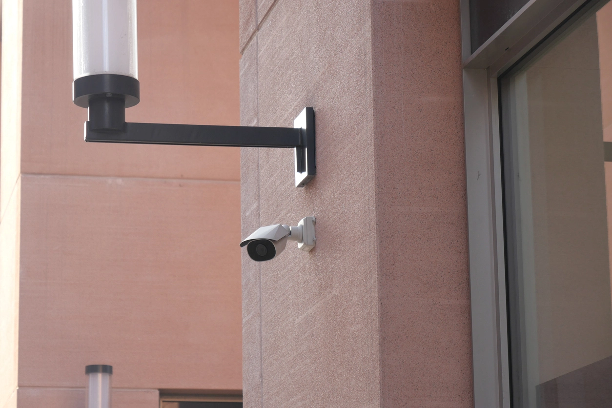 motion activated security camera recording building entrance activity