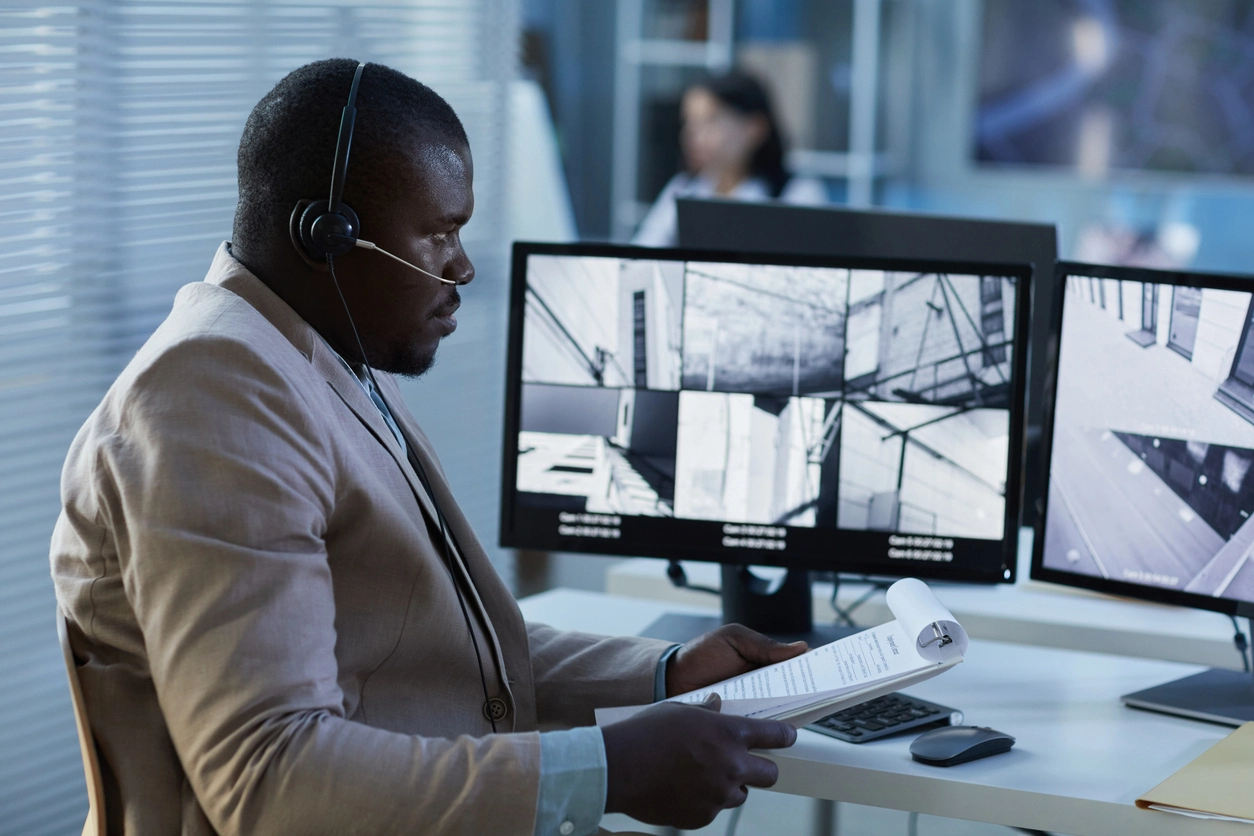 security monitoring room reviewing police department surveillance feeds