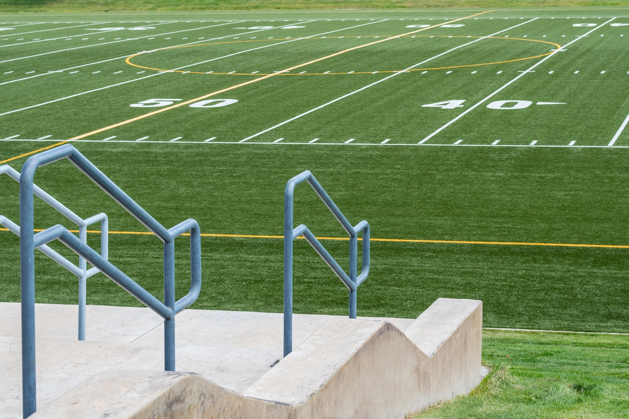 security camera monitoring entrance gate at school athletic field
