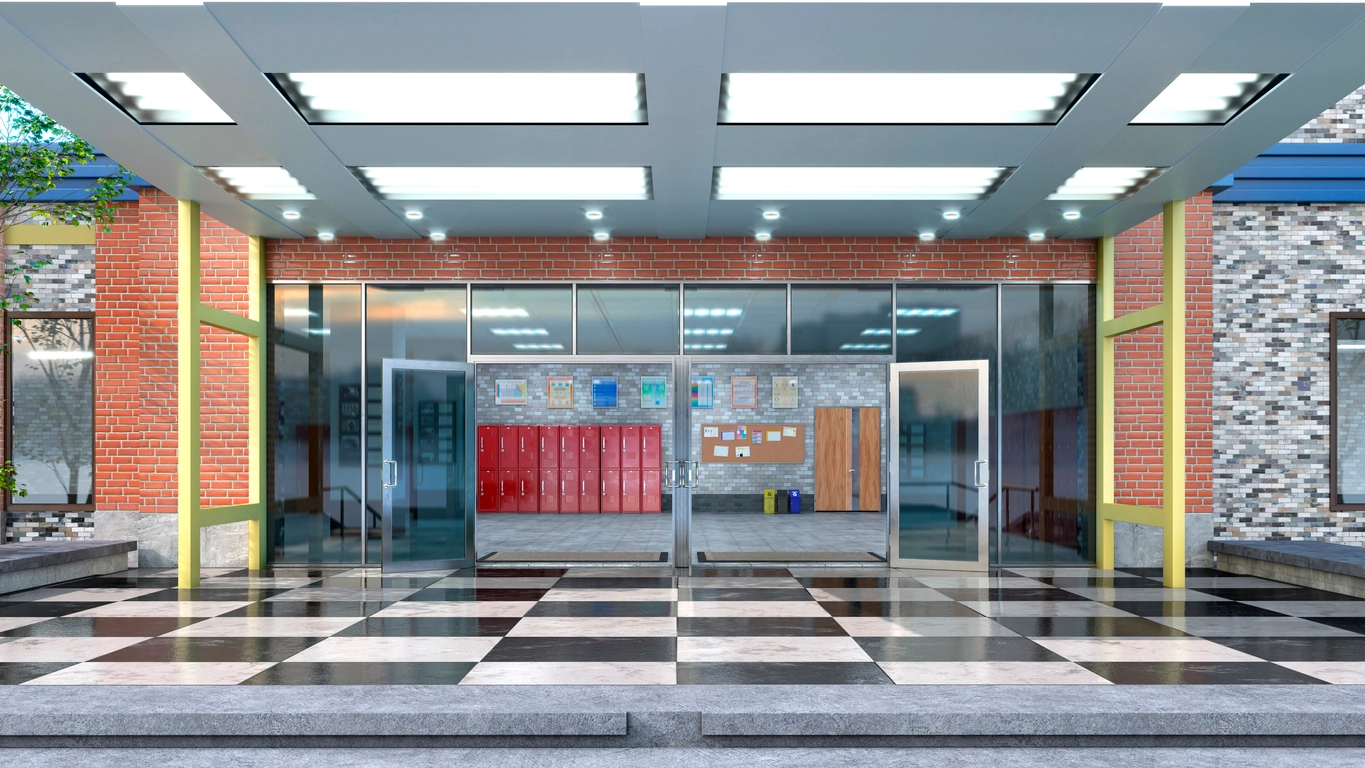 technician installing security camera in school hallway