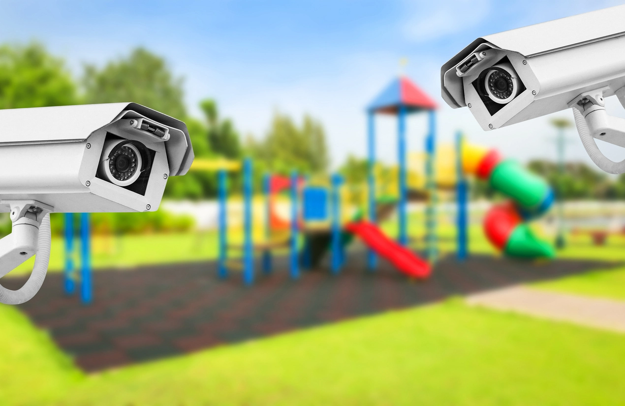 security camera monitoring walkway between school building and playground